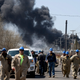 Workers evacuate from an explosion and fire at the Husky Energy oil refinery in Superior, Wisconsin on April 26, 2018. Several people were injured by the explosion and fire at the oil refinery, sending thick plumes of black smoke into the sky as authorities urged residents in the area to evacuate.